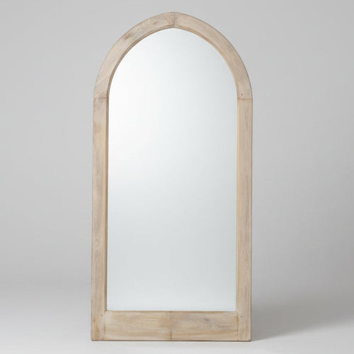Arched wooden mirror with a white wall and floor in the background