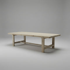 Wooden table on a concrete floor with a white wall in the background
