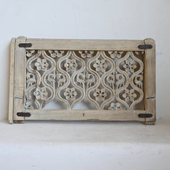 Decorative wooden panel with floral patterns on a white background