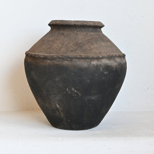 Black ceramic jar on a white background