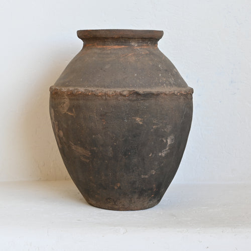 Vintage terracotta pot on a white background