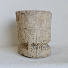 Wooden pot with carved patterns on a white background