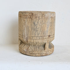 Wooden pot with textured surface on a white background