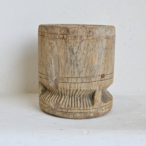 Wooden pot with a textured surface on a white background