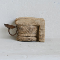 Wooden wall mount candle holder on a light grey background