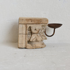 Wooden candle holder with rustic design on a white background