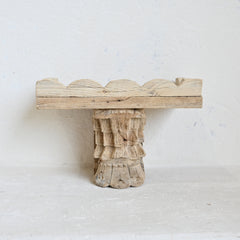 Wooden shelf with a textured base on a white background