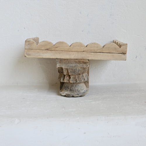 Wooden decorative shelf with scalloped edge on a white background