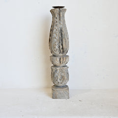 Decorative wooden candle holder with intricate carvings on a white background