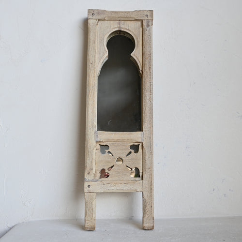 Wooden mirror with decorative frame on a white background