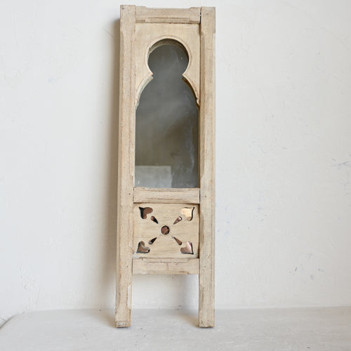 Wooden mirror with decorative frame on a white background