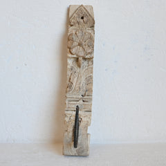 Decorative timber panel with intricate carvings  and a single hook on a white background