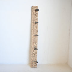 Vintage carved panel with metal hooks on a white background