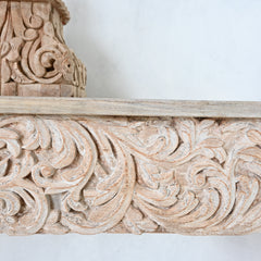 Close-up of ornate wooden carvings on a white background