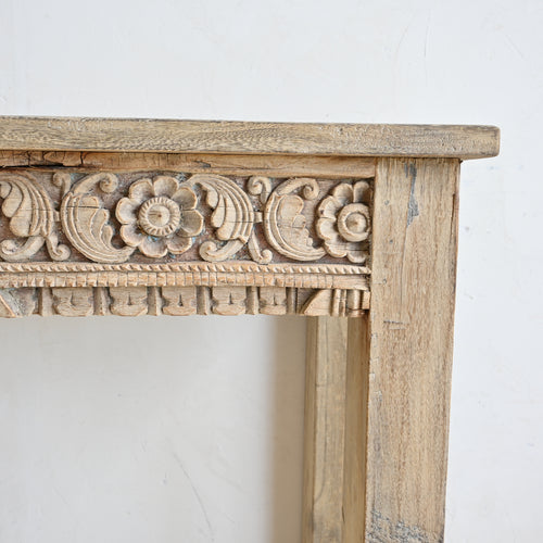 Wooden frame with intricate carvings on a white background
