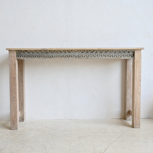 Wooden console table with decorative carvings on a white background