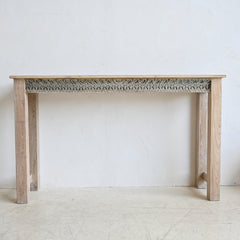 Wooden console table with decorative carvings on a white background
