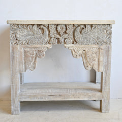 Carved wooden console table with intricate designs on a white background