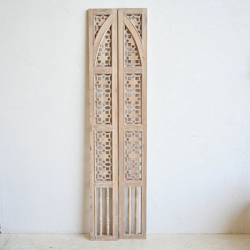 Pair of wooden panels with geometric patterns on a white background