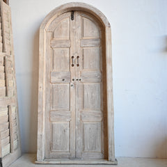 Wooden arched door with a white background