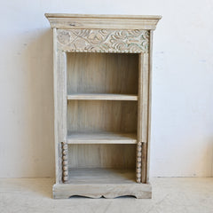 Wooden bookshelf with intricate carvings on a white background