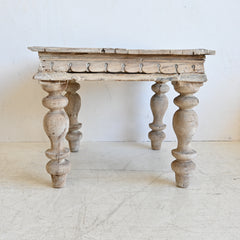 Vintage wooden table with turned legs on a white background